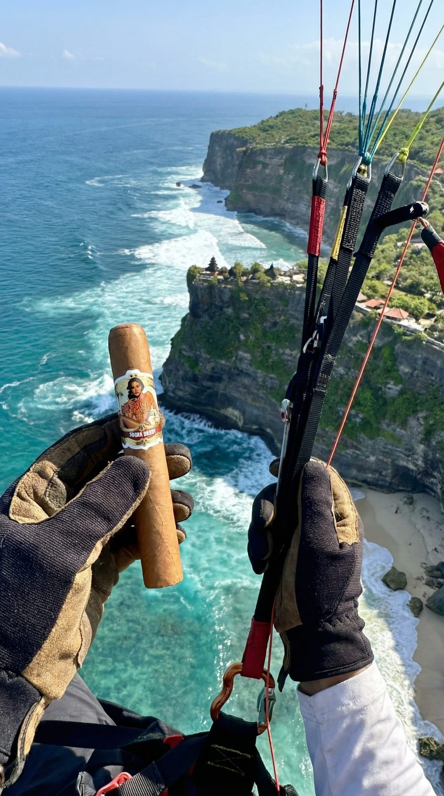 Man enjoying a premium Papasito cigar in a relaxed tropical setting